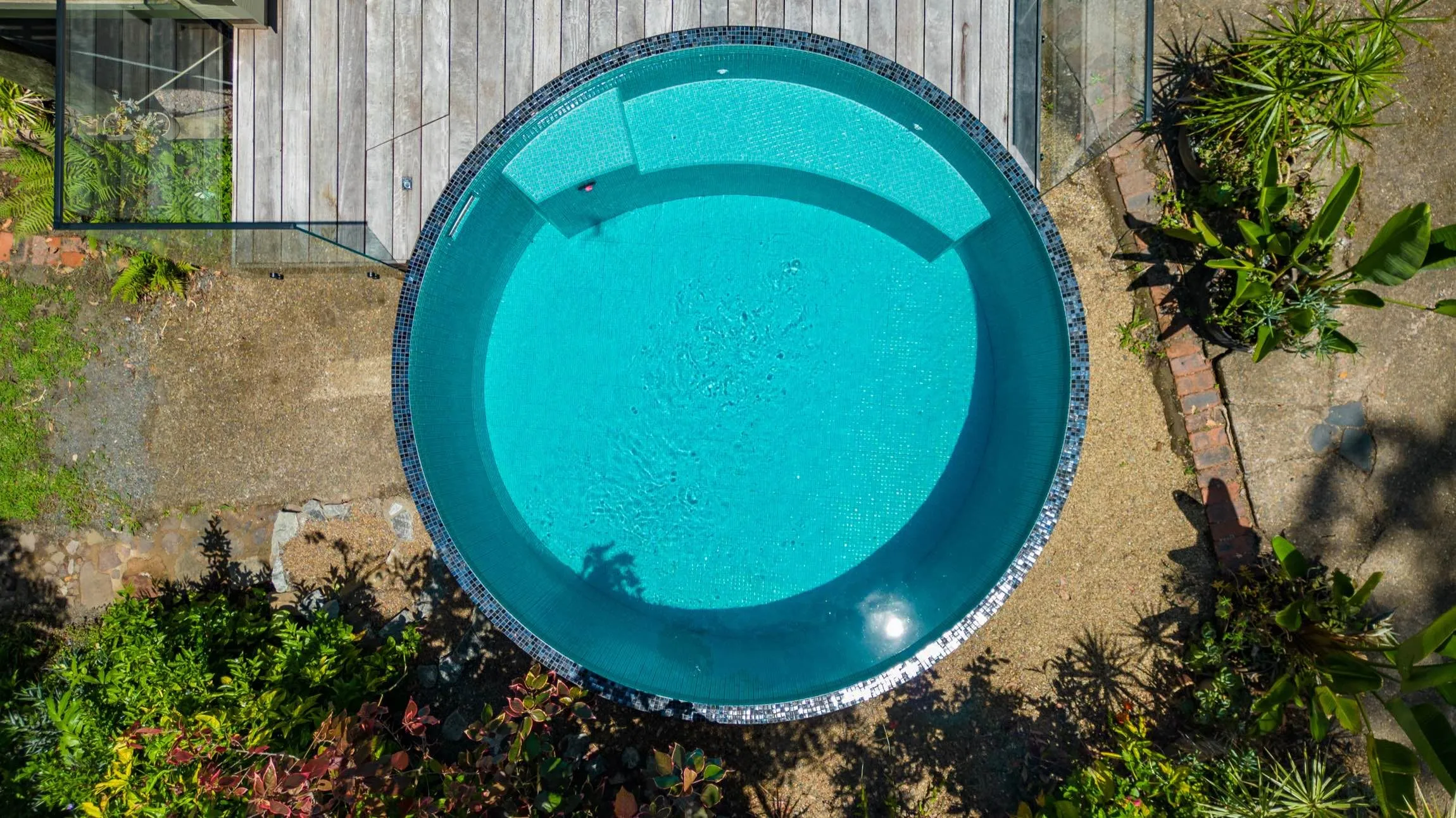 Aerial view of a round plunge pool in a garden