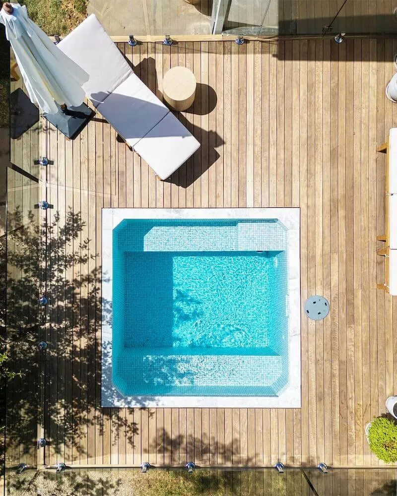 Top-down view of a square plunge pool in a timber deck