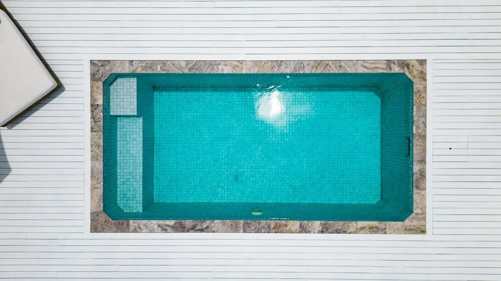Top-down view of a rectangular plunge pool in a white deck