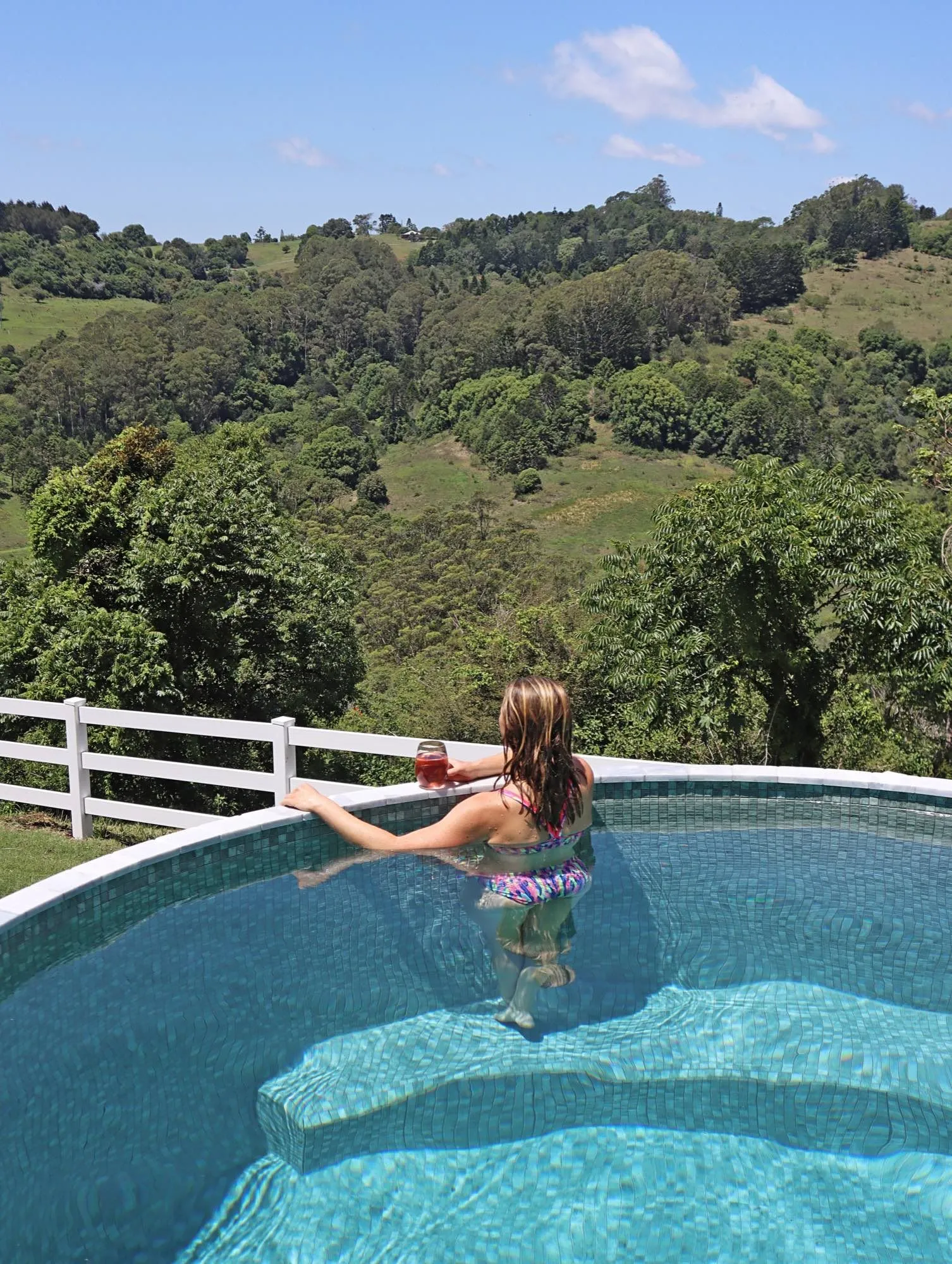 Woman looking out over the hills from a round plunge pool