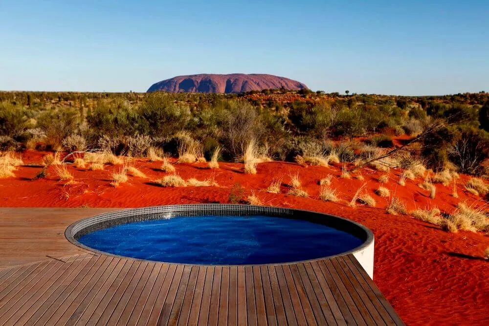 Round plunge pool set into a timber deck in the red-sand outback