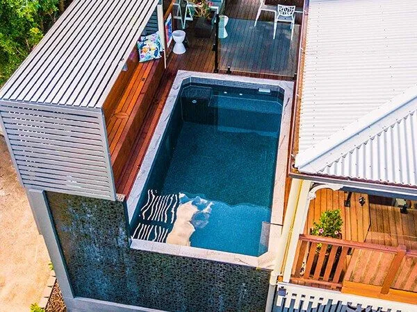 The Oasis rectangular plunge pool alongside a home