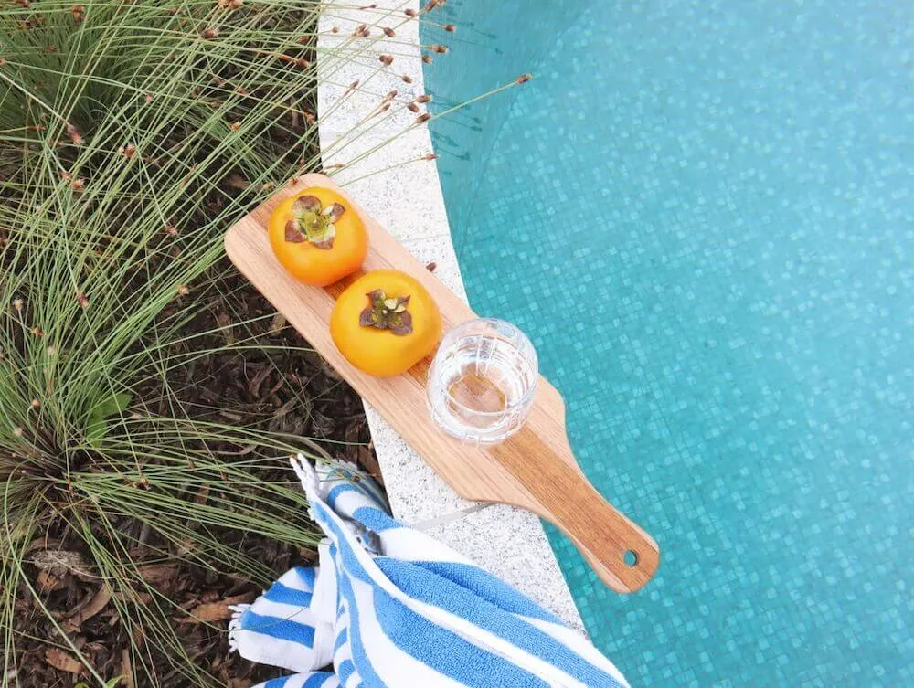 Serving board of fruit on the edge of a plunge pool
