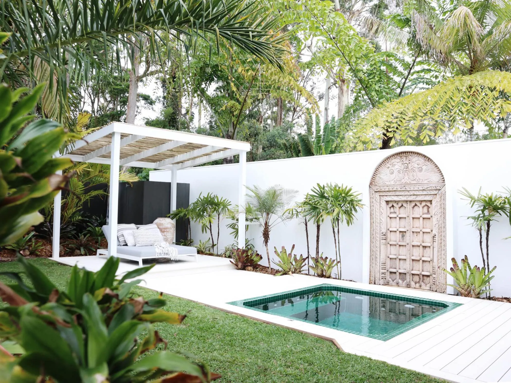 A fully tiled precast plunge pool set beside a covered outdoor living area