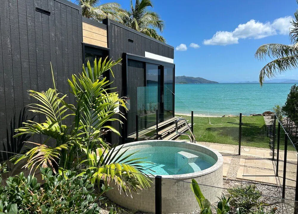 Round plunge pool in a garden overlooking the beach
