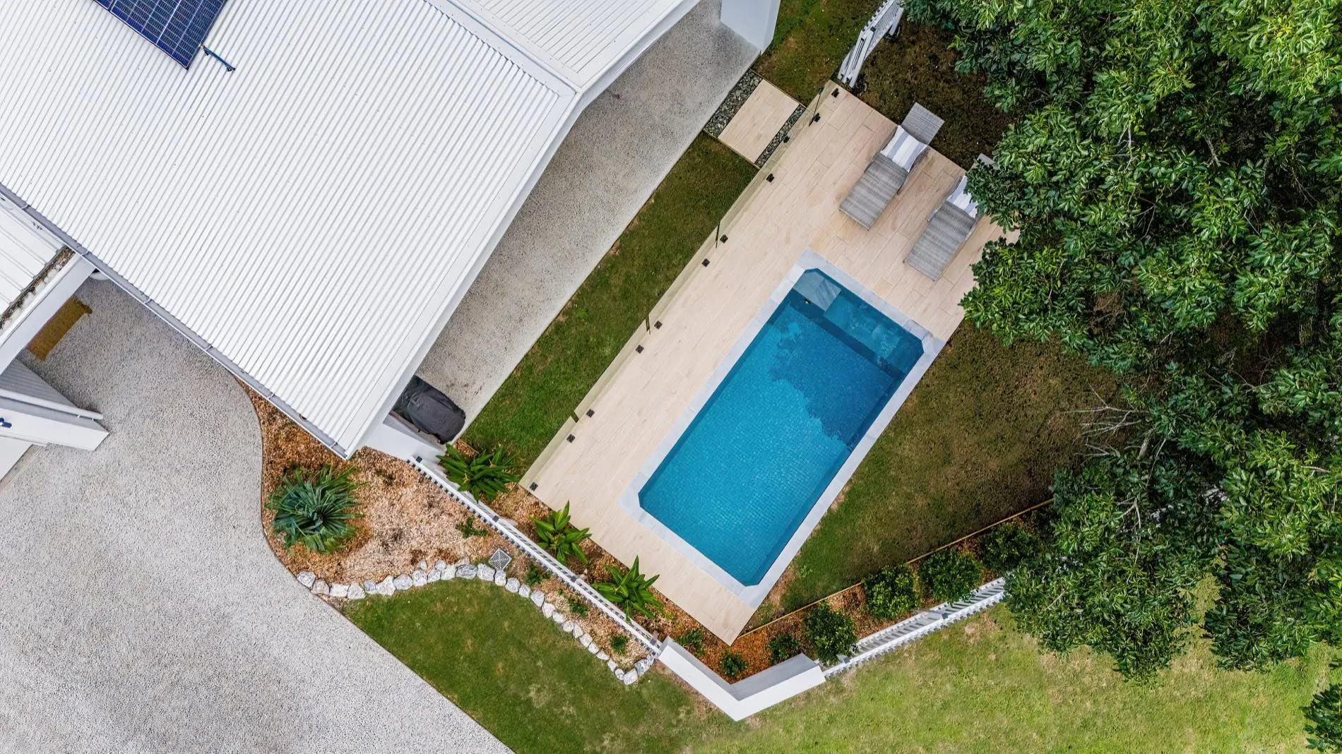 Aerial view of a rectangular plunge pool in a narrow side yard