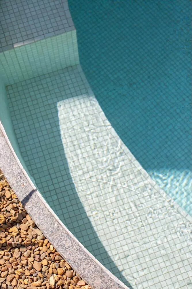 Looking down on the mosaic-tiled step inside a Bliss pool
